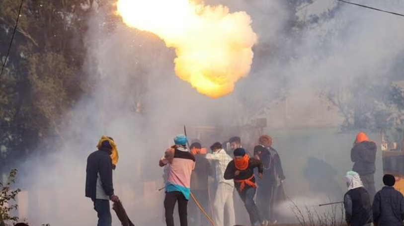 Farmers, marching towards New Delhi to press for better crop prices promised to them in 2021, run for cover as tear gas is fired by police to disperse them, at Shambhu, a border crossing between Punjab and Haryana states, India, February 14, 2024.